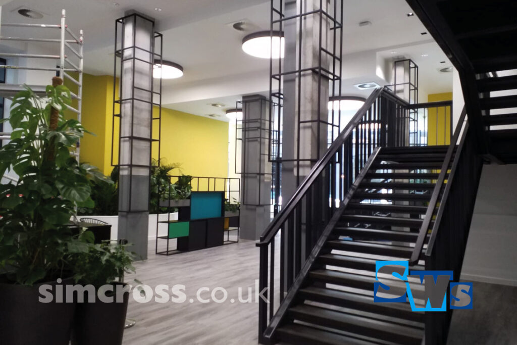 London – decorative steel frames fixed to concrete columns. Simcross Welding Services bespoke metalwork London and Herts