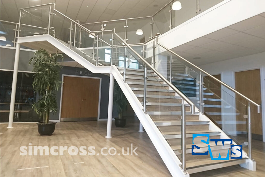 Interior railing and stairs fabricated and installed in welcome area at St Albans Vineyard Church in Hertfordshire.