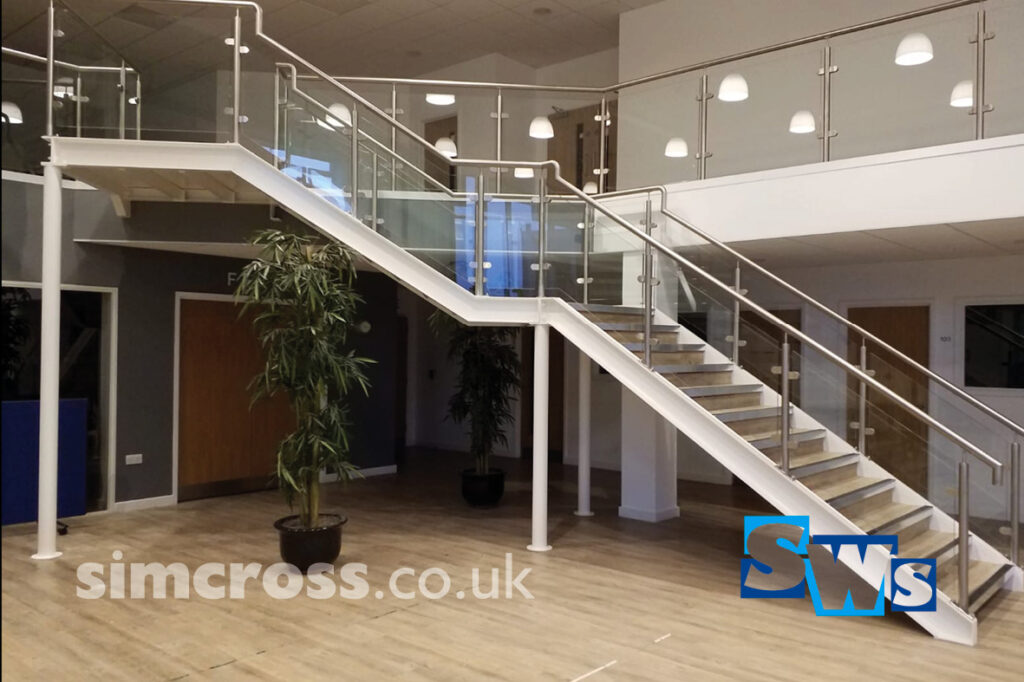 Interior railing and stairs fabricated and installed in welcome area at St Albans Vineyard Church in Hertfordshire.